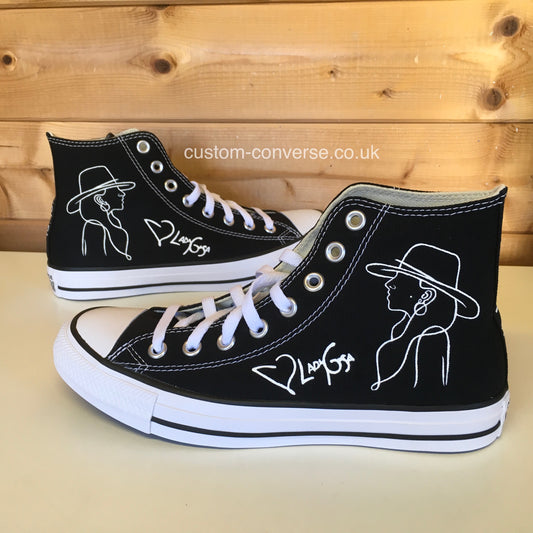 Hand-painted Lady Gaga Converse with white line drawing on black high-top trainers, side view