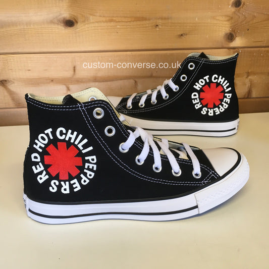 Red Hot Chili Peppers Converse with red and white band logo on black high-top trainers, side view
