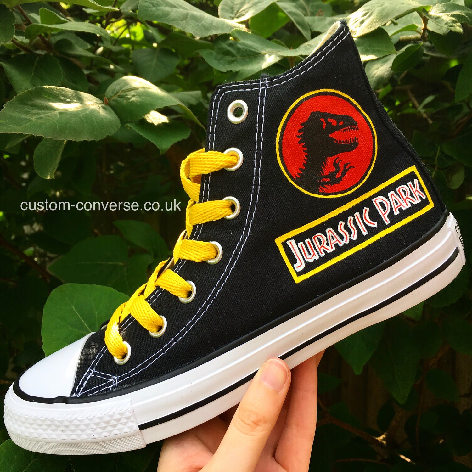 High top Converse hand-painted with the Jurassic Park logo from the TV and Film Designs