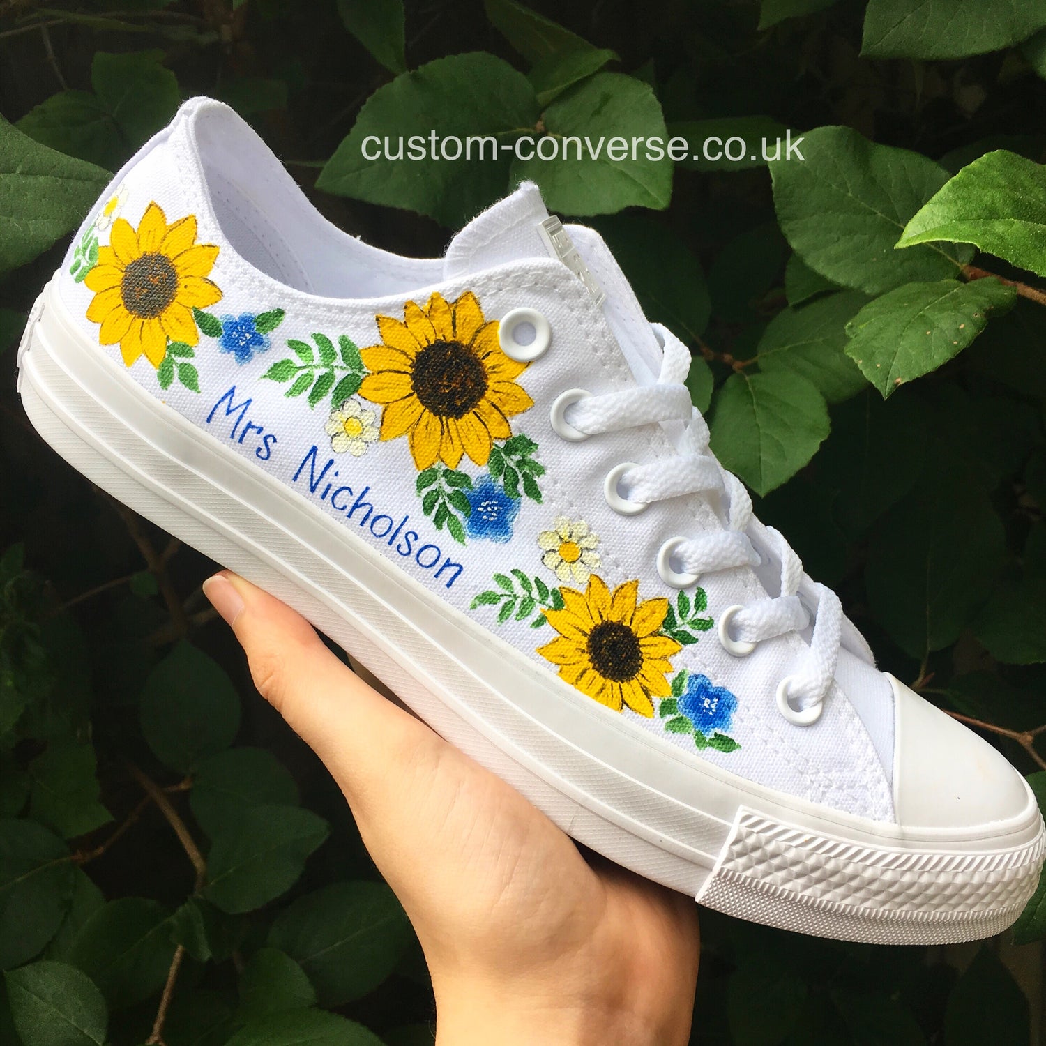 A pair of hand-painted Converse from the Nature Designs collection featuring bright sunflowers