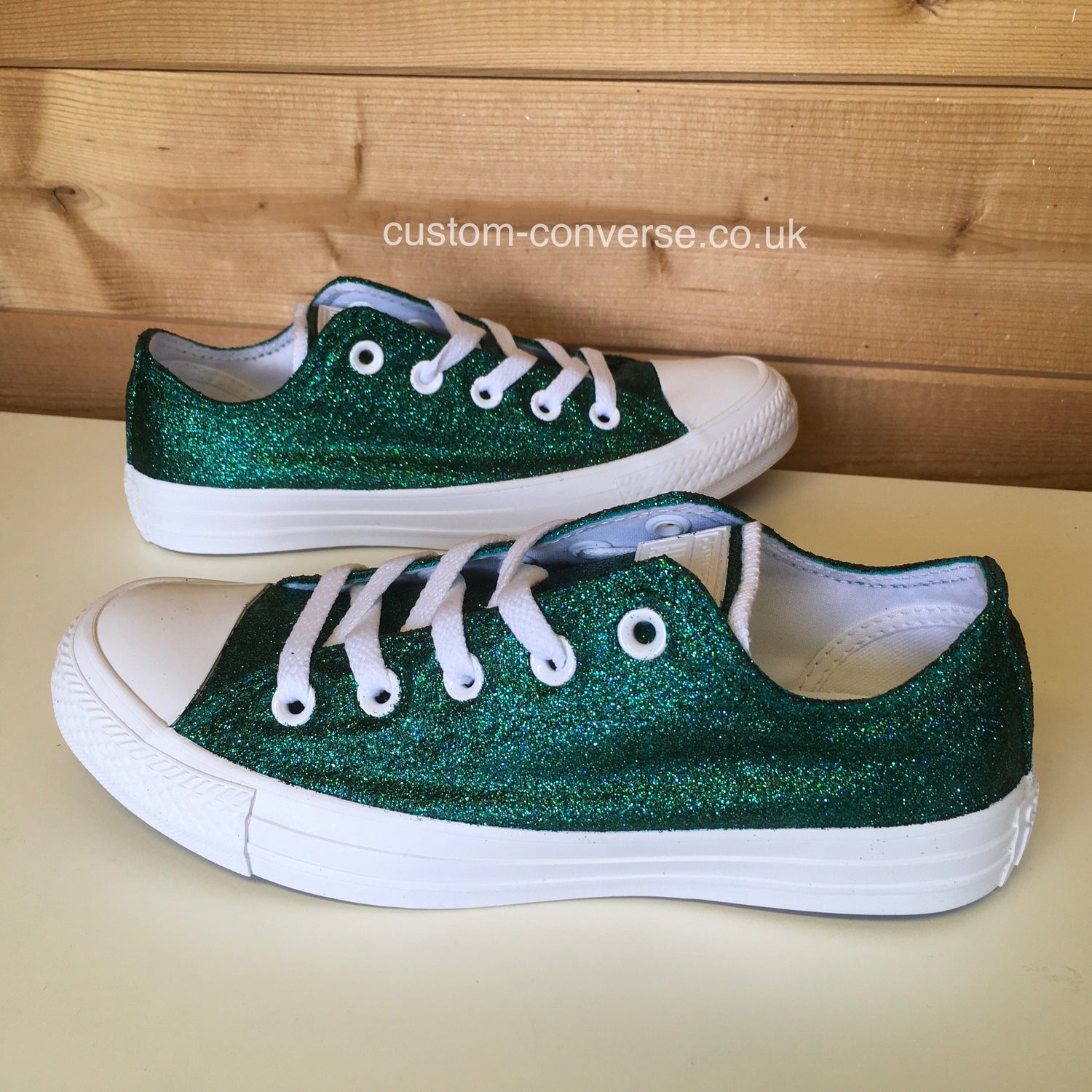 A pair of deep sea green glitter custom converse prom shoes